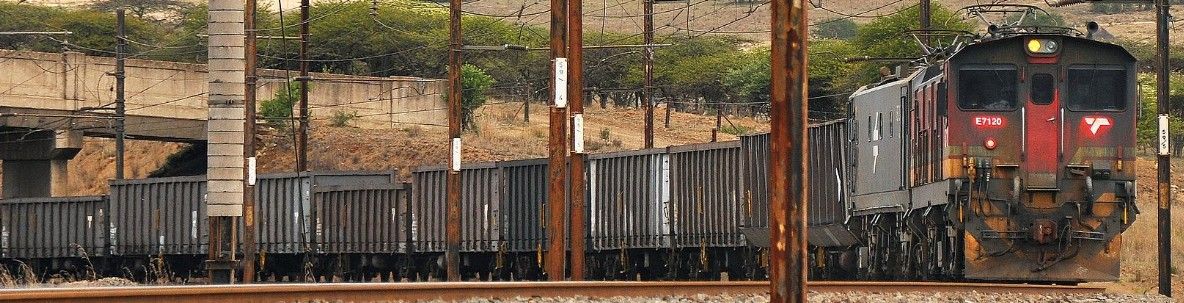Goods train with loaded wagons at a rail yard