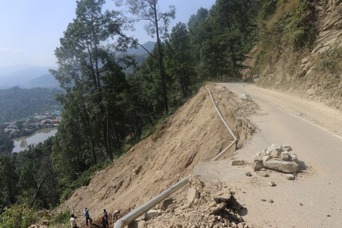 Landslide debris across a hill road above a valley